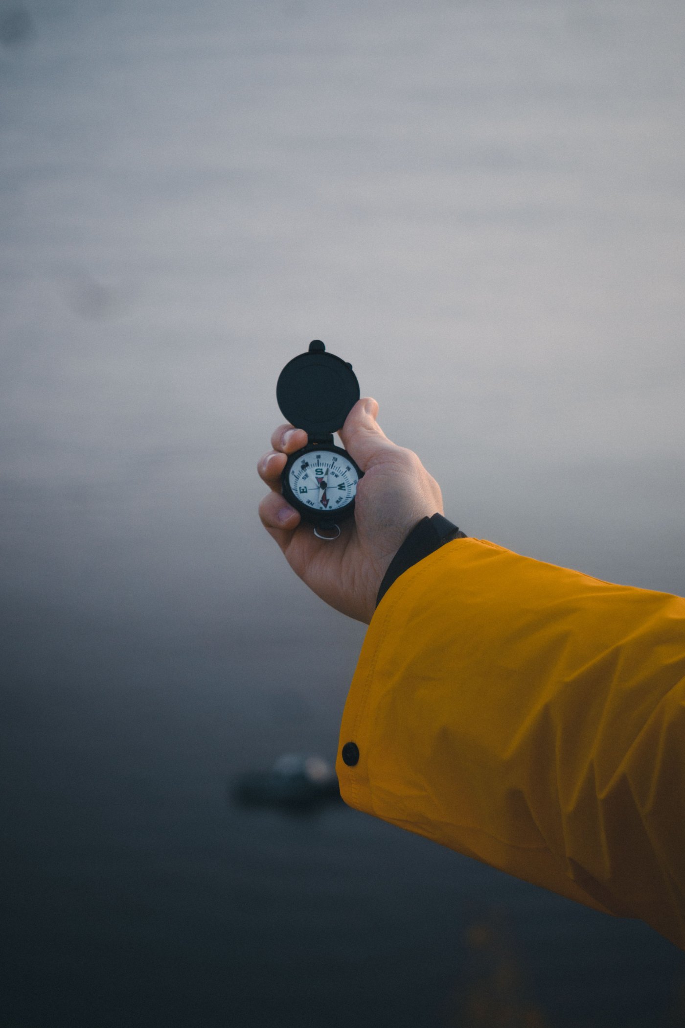 Hand holding an open compass